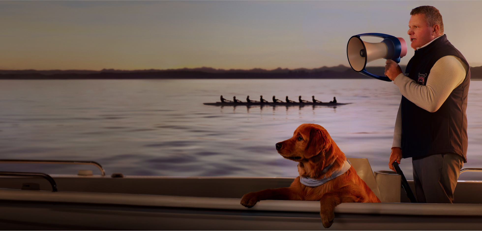 Guy Monseair holding megaphone coaching rowing team on lake with dog
