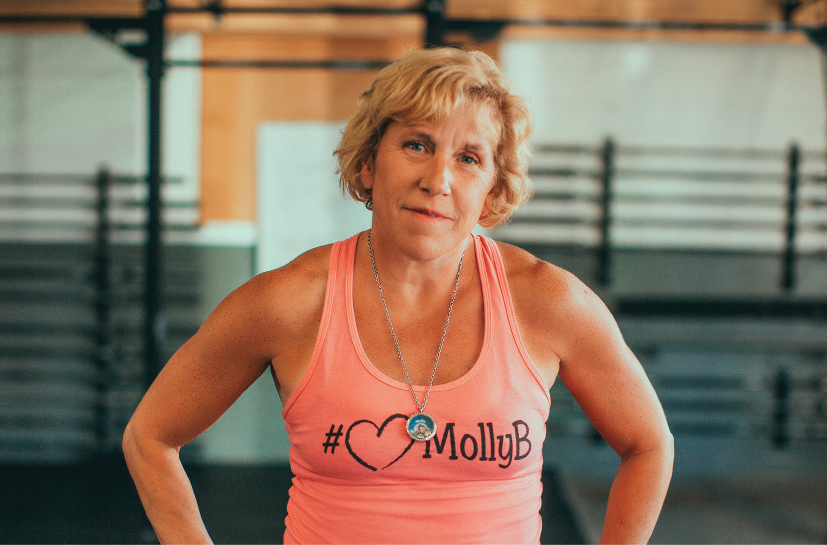 Barbara in a pink tank top with the #MollyB hashtag, for her daughter, at the gym.