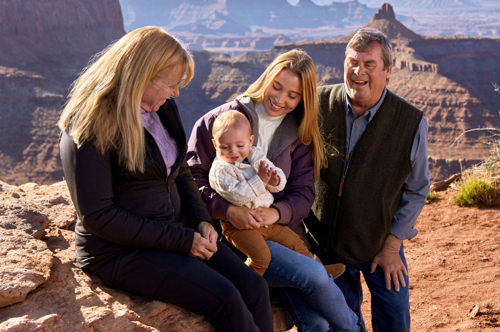 Barbara, baby Jack, daughter Gracie, and husband together framed by a mountain range.