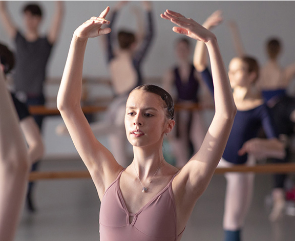 Chiara: a ballerina raising her arms over her head