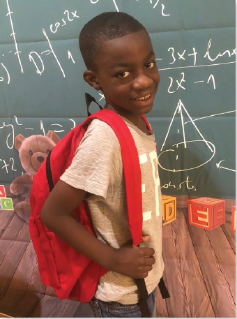 Eight-year-old Kareem Cooper with his                 new school supplies